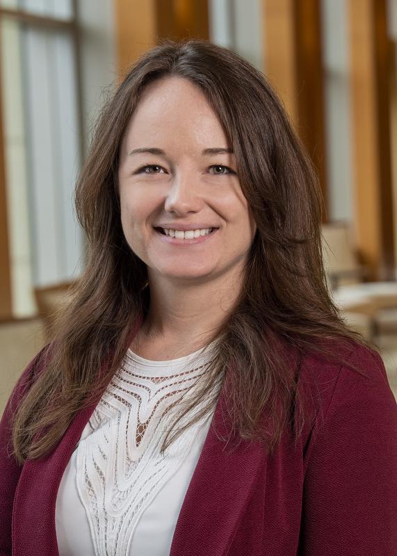 Dr. Alexandra Prosser, Dombroski in white shirt and dark red jacket
